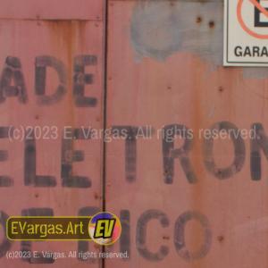 closeup of a reddish garage door with some text on it