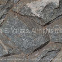 close-up of rocks on a wall, street, outdoors, daylight, zoom